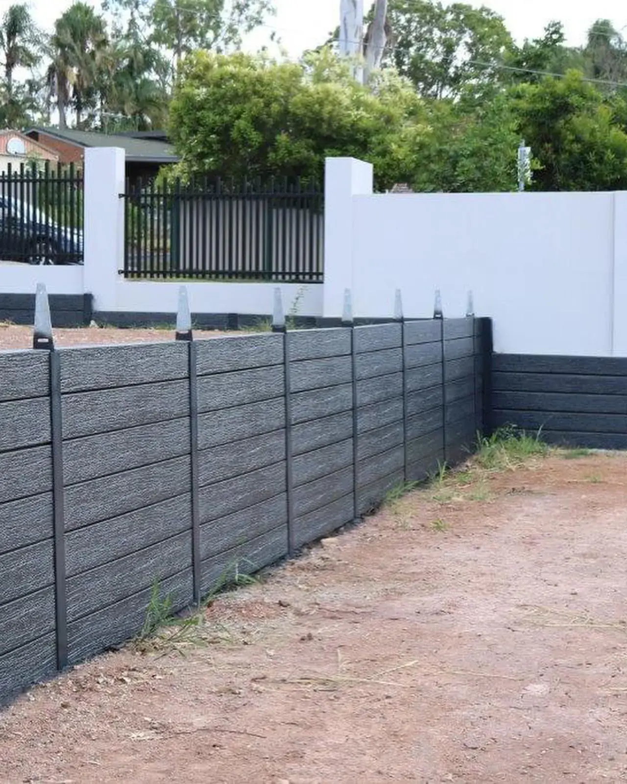 Premium all black concrete sleepers used for modern retaining walls and landscaping projects.